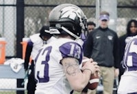 a football player is throwing a ball on the field
